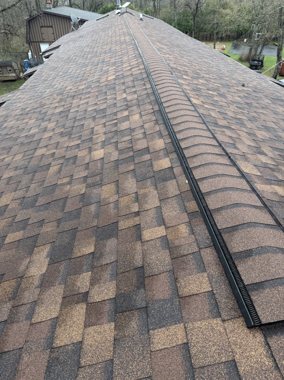 New ridge cap against a clear WNY sky &mdash; TNE Roofing & Siding